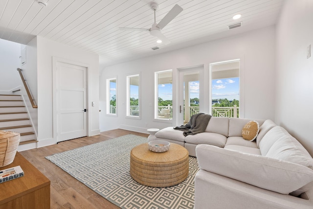 living room with light hardwood / wood-style floors, ceiling fan, and wooden ceiling