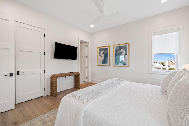 bedroom with ceiling fan and light wood-type flooring