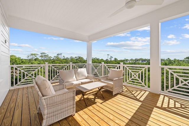 wooden terrace with ceiling fan and an outdoor hangout area