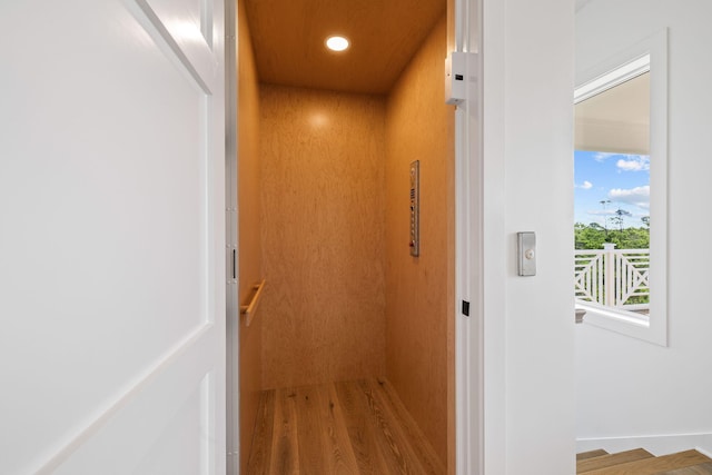 details featuring wood-type flooring and elevator