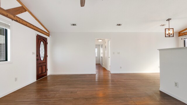 foyer with ceiling fan with notable chandelier, dark wood-type flooring, and vaulted ceiling