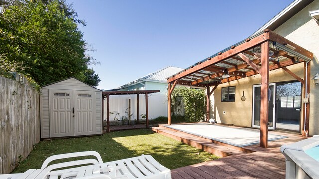 wooden terrace with a yard and a shed