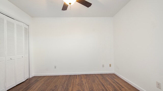 unfurnished bedroom featuring dark hardwood / wood-style floors, ceiling fan, and a closet