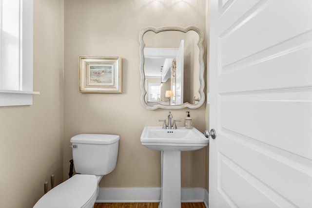 bathroom featuring hardwood / wood-style flooring, toilet, and sink