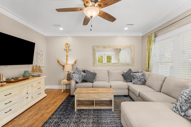 living room with crown molding, ceiling fan, and wood-type flooring