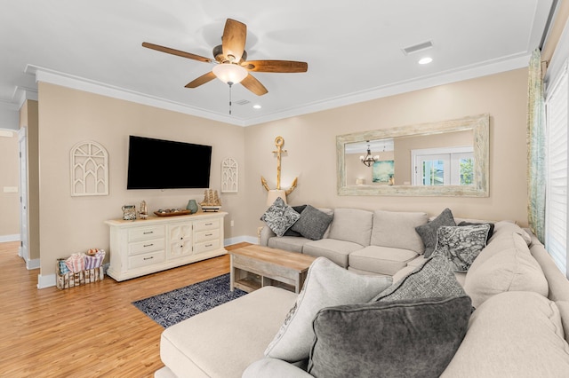 living room featuring ornamental molding, ceiling fan with notable chandelier, and light wood-type flooring