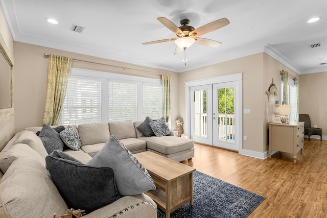 living room with ceiling fan, light wood-type flooring, ornamental molding, and french doors