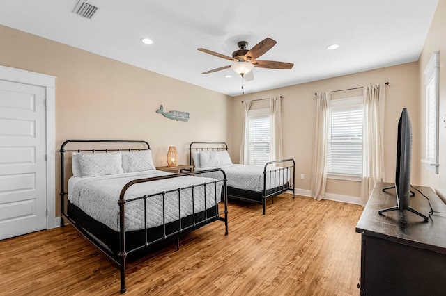 bedroom with ceiling fan and light hardwood / wood-style floors