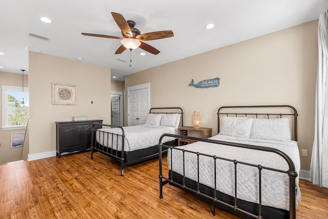 bedroom with light wood-type flooring and ceiling fan