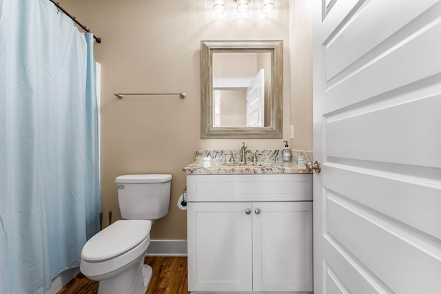 bathroom featuring a shower with shower curtain, wood-type flooring, vanity, and toilet