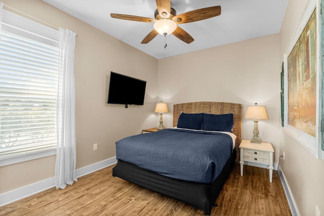 bedroom featuring ceiling fan and light hardwood / wood-style flooring