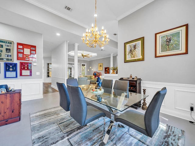 dining space with ceiling fan with notable chandelier, wood-type flooring, and crown molding