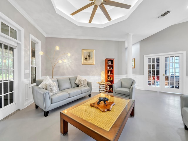 living room with french doors, vaulted ceiling, ceiling fan, crown molding, and concrete floors