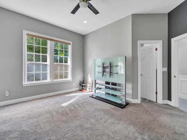 unfurnished living room featuring carpet and ceiling fan