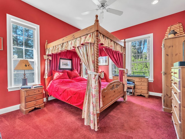 carpeted bedroom with multiple windows and ceiling fan