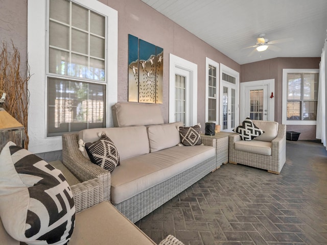 sunroom featuring ceiling fan and a healthy amount of sunlight