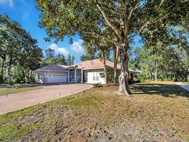 single story home featuring a front yard and a garage