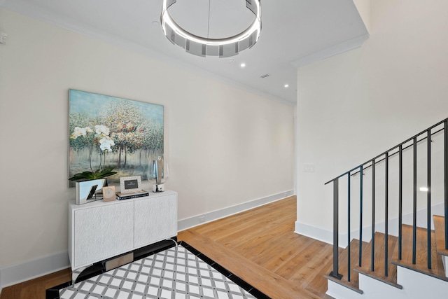 foyer entrance featuring hardwood / wood-style flooring and ornamental molding