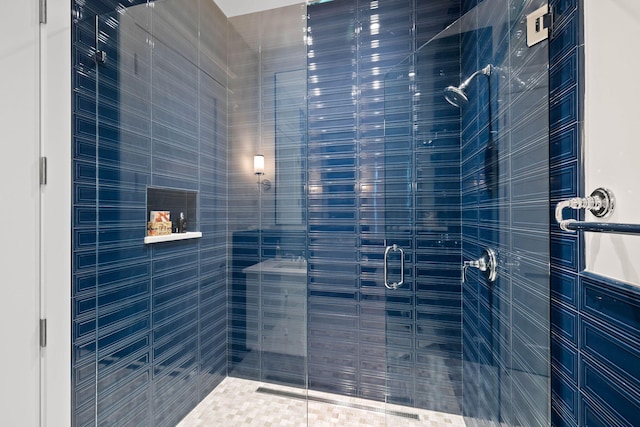 bathroom with a shower with door