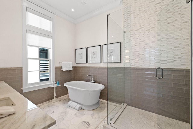 bathroom with vanity, separate shower and tub, tile walls, and crown molding