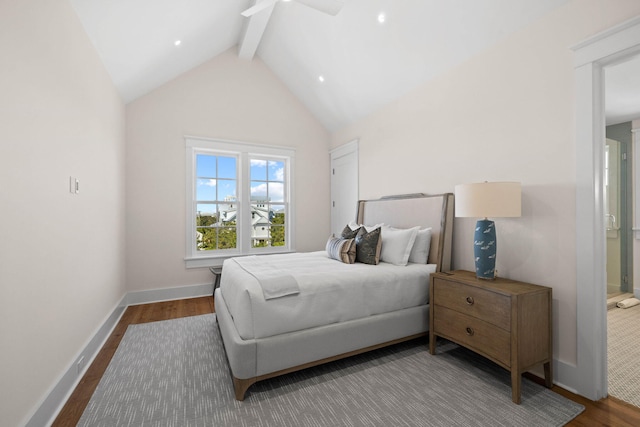 bedroom featuring ensuite bath, ceiling fan, wood-type flooring, and lofted ceiling with beams