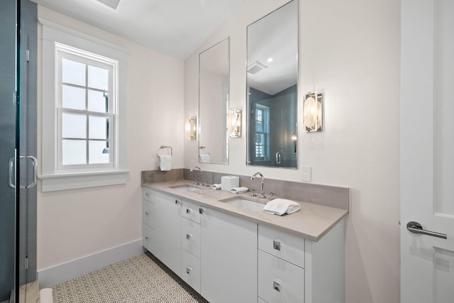 bathroom featuring tile patterned floors, vanity, and lofted ceiling