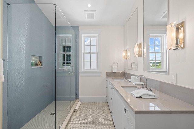 bathroom featuring vanity, tile patterned floors, and walk in shower