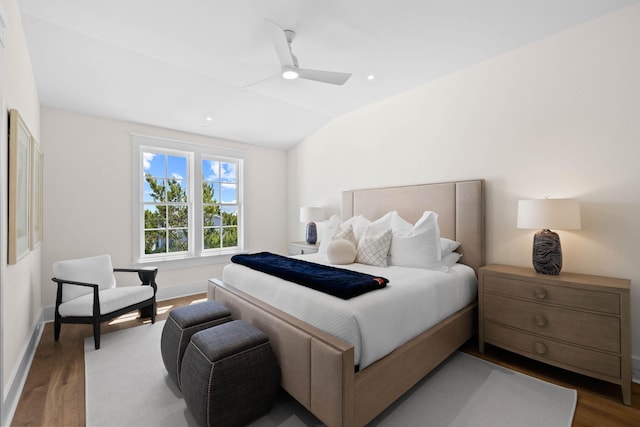 bedroom featuring ceiling fan, wood-type flooring, and vaulted ceiling