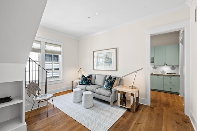 living room featuring hardwood / wood-style floors and crown molding