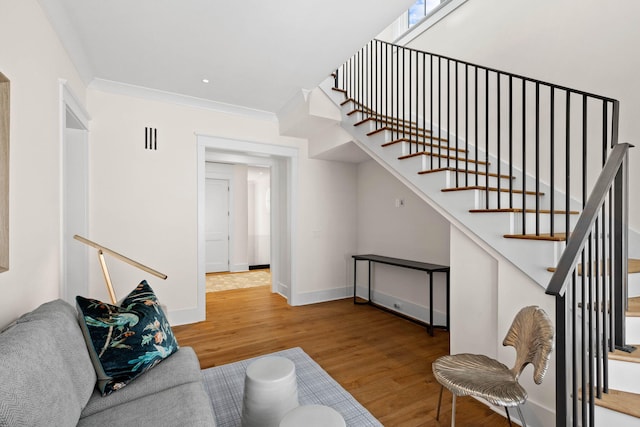 interior space featuring crown molding and hardwood / wood-style floors