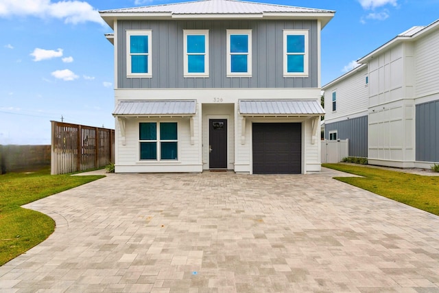 326 E Lakeshore Dr, Panama City Beach, FL 32413 - view of front of home with board and batten siding, decorative driveway, an attached garage, and a metal roof