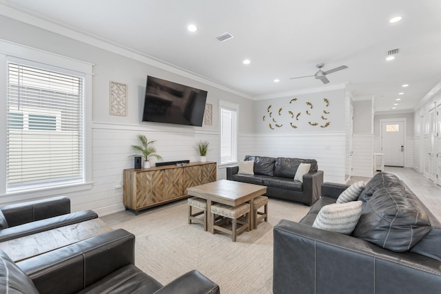 living room with ceiling fan, a healthy amount of sunlight, and crown molding