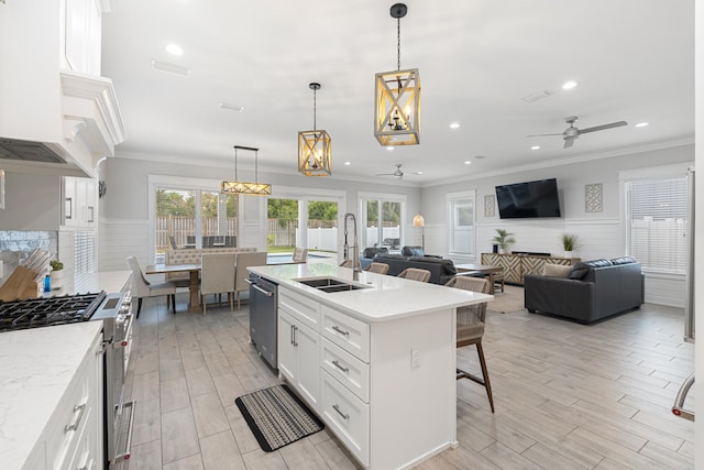 kitchen featuring white cabinets, pendant lighting, ceiling fan with notable chandelier, and stainless steel appliances