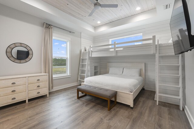 bedroom with a raised ceiling, ceiling fan, dark hardwood / wood-style flooring, and wooden ceiling