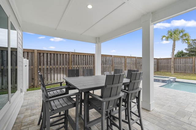 326 E Lakeshore Dr, Panama City Beach, FL 32413 - wooden deck with a patio area, a fenced backyard, a pool with connected hot tub, and outdoor dining space