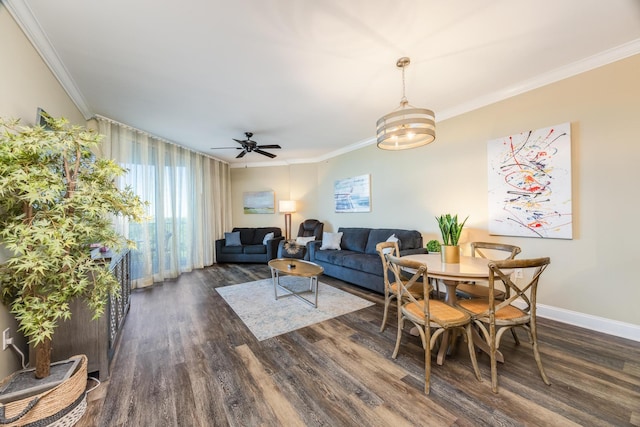 dining area featuring ceiling fan with notable chandelier, dark hardwood / wood-style floors, and ornamental molding