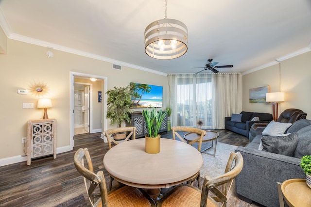 dining space with ceiling fan, ornamental molding, and dark wood-type flooring