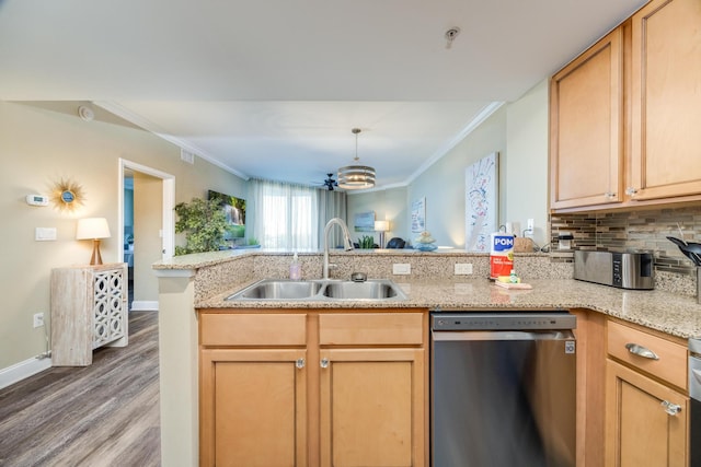 kitchen with dishwasher, sink, kitchen peninsula, crown molding, and hardwood / wood-style floors