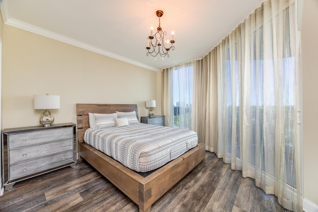 bedroom with crown molding, dark hardwood / wood-style flooring, and a chandelier