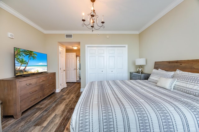 bedroom featuring a notable chandelier, a closet, dark hardwood / wood-style floors, and ornamental molding