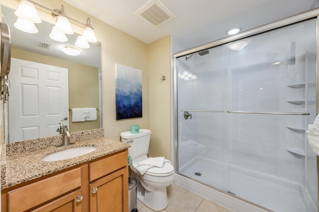 bathroom with tile patterned floors, vanity, walk in shower, and toilet