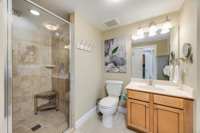 bathroom featuring tile patterned floors, vanity, toilet, and a shower with door