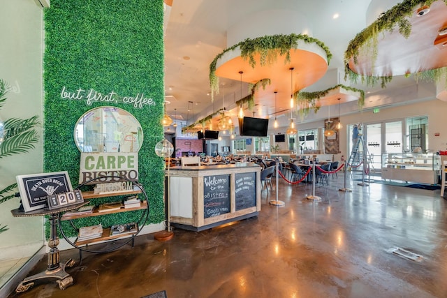 bar featuring pendant lighting and concrete floors