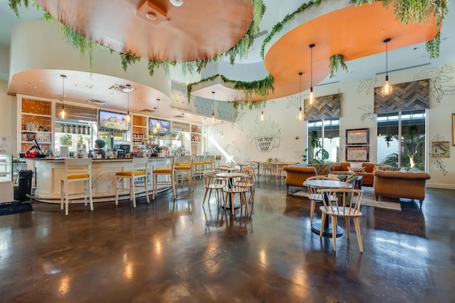 dining area with a towering ceiling