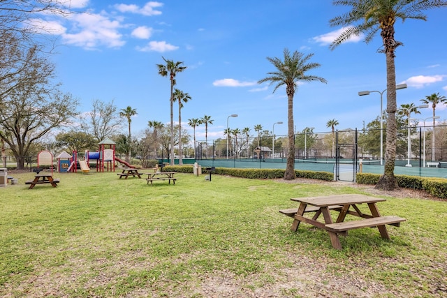 surrounding community with a yard, a playground, and tennis court