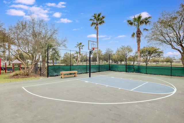 view of basketball court featuring a playground