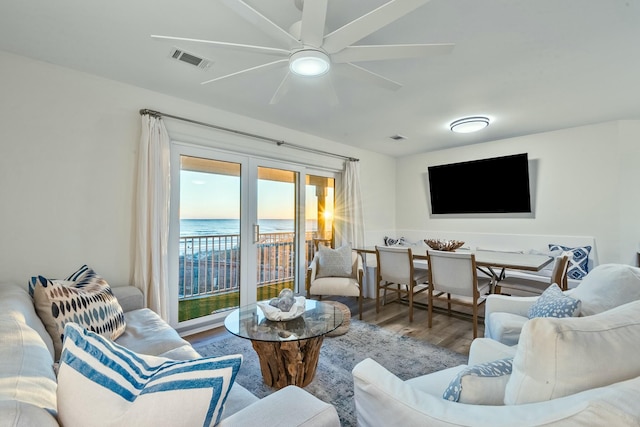 living room featuring hardwood / wood-style floors and ceiling fan