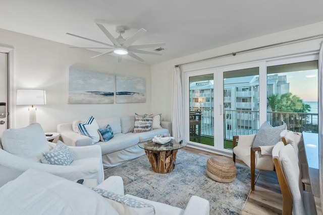 living room featuring ceiling fan and wood-type flooring