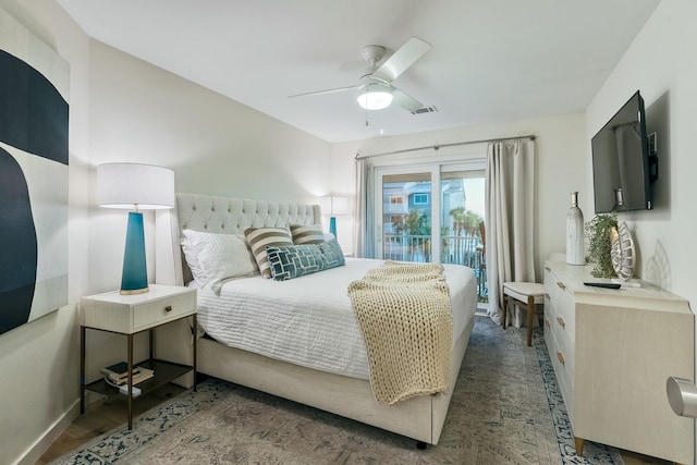 bedroom featuring ceiling fan, dark wood-type flooring, and access to outside