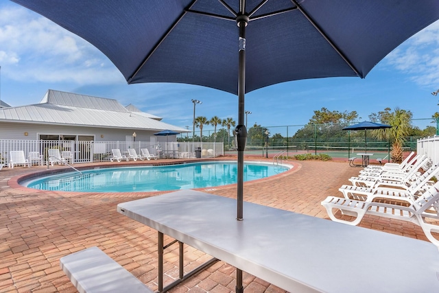 view of pool featuring tennis court